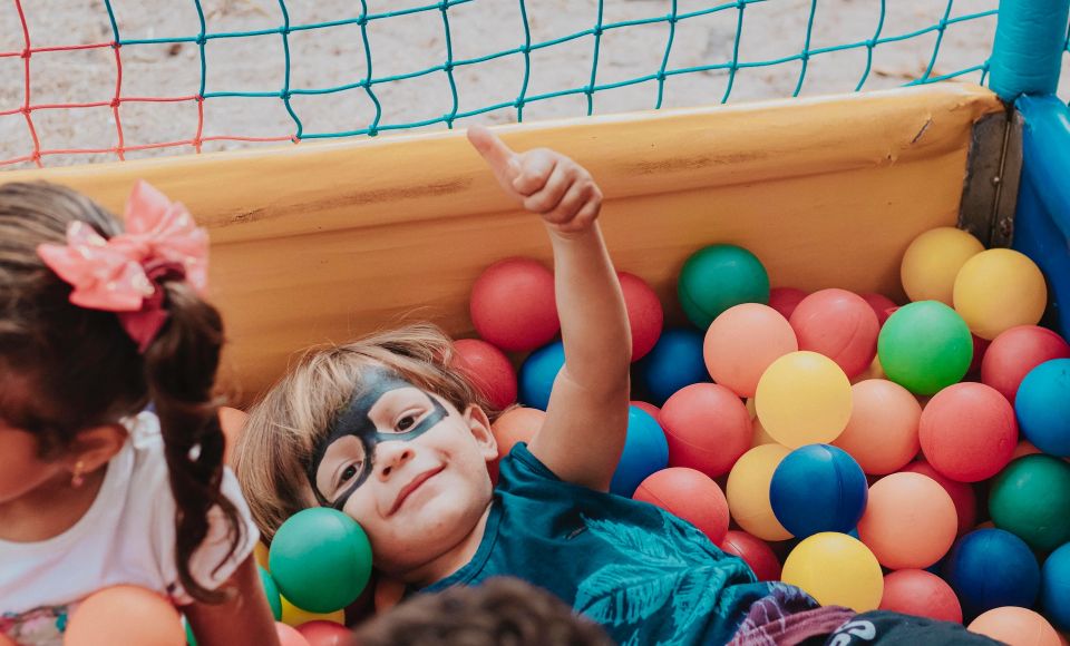 Two children playing in a ball pit