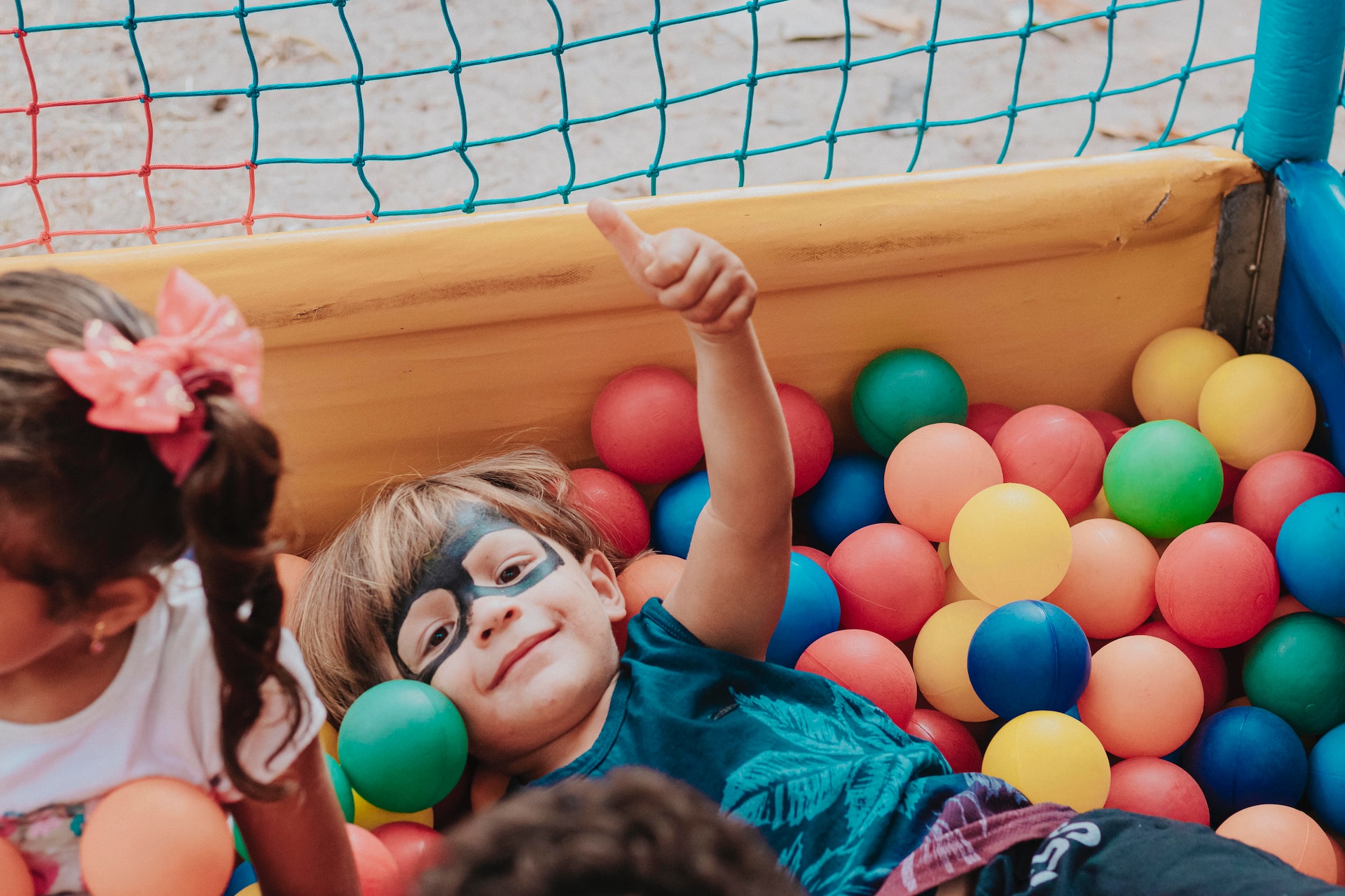 Two children playing in a ball pit